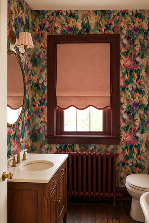 Margot wallpaper by Curate Space in green, painterly roses and wildflowers in a bathroom with a radiator and wooden vanity