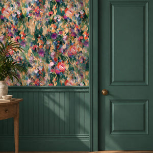 Margot wallpaper by Curate Space in green, painterly roses and wildflowers in a hallway above green panelling