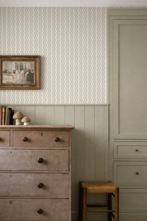 Mia wallpaper by Curate Space in olive green, rows of dots forming a stripe in a bedroom above a wooden chest of drawers