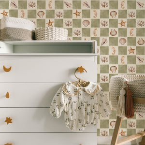 Molly wallpaper by Curate Space in soft green, seashells and seahorses on a check in a nursery with a white changing table