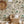 Noah wallpaper by Curate Space in pebble grey, palm trees, tropical foliage and animals in a nursery with a wicker chair and a rattan sun mirror