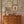 Nola wallpaper by Curate Space in off-white, wildflowers and tall stems in a bedroom with pink panelling and a wooden chest of drawers