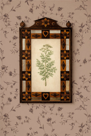 Paloma wallpaper by Curate Space in dark pink, close-up of trailing floral stems behind a decorative inlaid mirror