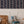 Ren wallpaper by Curate Space in midnight blue, wavy stripes with bugs and butterflies in a nursery with a wicker basket and armchair