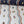 Ren wallpaper by Curate Space in off-white and midnight blue, wavy stripes with bugs and butterflies, rolls in off-white and midnight shown together