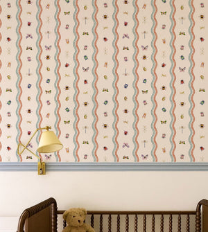 Ren wallpaper by Curate Space in off-white, wavy stripes with bugs and butterflies in a nursery with a wooden cot