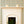 Rosalie wallpaper by Curate Space in soft green, a scalloped stripe in a room with a fireplace and a potted plant
