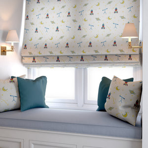 Float Away into Space linen by Annika Reed in cream, rockets, moons and planets as a roman blind