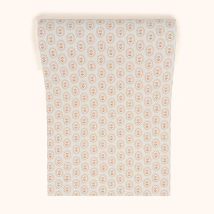 Folly wallpaper by Parker and Jules in beige, roll showing small sunburst medallions