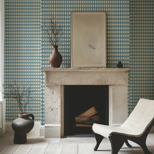 Harlequin Parade wallpaper by Annika Reed in blue, a small harlequin check around a fireplace