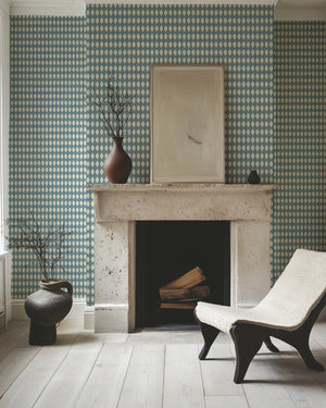 Harlequin Parade wallpaper by Annika Reed in blue, a small harlequin check around a fireplace