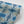 Indigo Itajime wallpaper by Tatie Lou in blue, partly unrolled roll showing itajime shibori folds