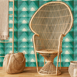 Motif wallpaper by Tatie Lou in green, geometric pyramids in a living room