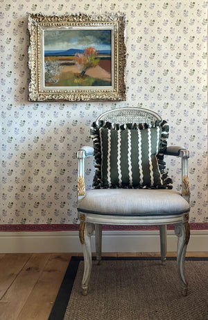 Jaipur wallpaper by Parker and Jules in beige and green, block-print flowers on a trellis upholstered on an armchair