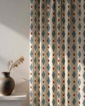 Ludo linen by Annika Reed in blue and red, diamonds and dots made into curtains