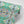 Franny wallpaper by Tatie Lou in pink and green, roll showing a kaleidoscopic floral