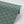 Mumbai Deco wallpaper by Tatie Lou in teal, partly unrolled roll showing Deco fan shapes