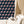 Pegasus wallpaper by Annika Reed in navy and pink, winged horses behind a sofa in a living room
