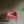 Plume wallpaper by Tatie Lou in pink and gold, Deco plumes behind a sofa in a living room