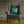 Plume wallpaper by Tatie Lou in navy and gold, Deco plumes upholstered on an armchair