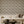 Velour Éventail wallpaper by Dami and Em Design in champagne, fan motifs on a living room wall behind a sofa