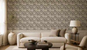 Velour Éventail wallpaper by Dami and Em Design in champagne, fan motifs on a living room wall behind a sofa