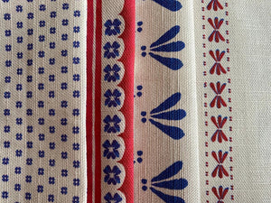 Wild Flower linen by Bethie Tricks in red and blue, the stripe on the right shown beside three other blue and red Bethie Tricks fabrics
