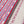 Wild Flower linen by Bethie Tricks in red and blue, draped close-up beside a red and blue scalloped stripe fabric