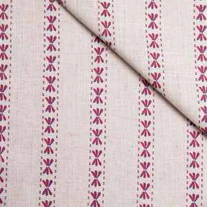 Wild Flower linen by Bethie Tricks in red and blue, vertical stripes of dragonfly-like motifs with a fold of fabric across the corner